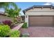 Charming single-story home with brick walkway, mature landscaping and a two-car garage at 2592 Brassica Dr, North Port, FL 34289