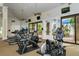 Bright gym with modern fitness equipment and views through large glass windows for an invigorating workout experience at 2592 Brassica Dr, North Port, FL 34289
