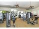 Large gym with Cybex equipment, mirrored walls and ceiling fans that create a clean and inviting space for workouts at 2592 Brassica Dr, North Port, FL 34289