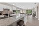 Bright kitchen showcasing granite counters, stainless appliances, and open layout to dining area at 2592 Brassica Dr, North Port, FL 34289
