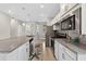 Bright kitchen boasts white cabinets, stainless steel appliances, and granite countertops at 2592 Brassica Dr, North Port, FL 34289