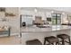 Kitchen with stainless steel refrigerator and island with granite countertops at 2592 Brassica Dr, North Port, FL 34289