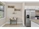Bright eating area with stainless steel refrigerator, view to the outside and adjacent kitchen at 2592 Brassica Dr, North Port, FL 34289
