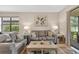 Living room featuring dual sofas and access to a screened patio at 2592 Brassica Dr, North Port, FL 34289