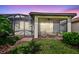 Screened patio area with cozy seating, perfect for evening relaxation and enjoying twilight at 2592 Brassica Dr, North Port, FL 34289