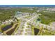 Expansive aerial view of a community with homes near lush landscapes, ponds, and distant ocean views at 267 Talquin Ct, Englewood, FL 34223