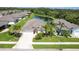 Aerial view of a well-manicured home with lush landscaping and a tranquil pond in the backyard at 267 Talquin Ct, Englewood, FL 34223