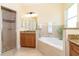 Bright bathroom featuring a soaking tub and separate shower with granite countertops at 267 Talquin Ct, Englewood, FL 34223