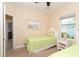 Well-lit bedroom featuring twin beds with views of tropical landscaping at 267 Talquin Ct, Englewood, FL 34223