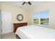 Bedroom featuring neutral walls, a ceiling fan, and a great view of a pond at 267 Talquin Ct, Englewood, FL 34223