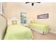 Cozy bedroom featuring twin beds and ample natural light at 267 Talquin Ct, Englewood, FL 34223