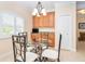 Bright breakfast nook featuring an elegant glass table, designer chairs and view at 267 Talquin Ct, Englewood, FL 34223