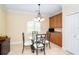 Bright breakfast nook with a glass table, designer chandelier, and custom cabinetry at 267 Talquin Ct, Englewood, FL 34223