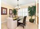 Elegant dining area with a glass table, and large windows offering ample natural light at 267 Talquin Ct, Englewood, FL 34223