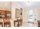 Inviting foyer with decorative mirror, tile flooring, and views into kitchen at 267 Talquin Ct, Englewood, FL 34223