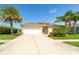 Inviting single-story home featuring lush landscaping, a two-car garage, and a well-manicured lawn at 267 Talquin Ct, Englewood, FL 34223