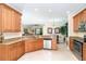 Spacious kitchen featuring custom wood cabinets, granite countertops, and stainless steel appliances at 267 Talquin Ct, Englewood, FL 34223