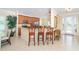 Open-concept kitchen with granite countertops, breakfast bar, and stainless steel appliances at 267 Talquin Ct, Englewood, FL 34223