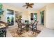 Covered lanai with an outdoor dining set and views of the surrounding landscape at 267 Talquin Ct, Englewood, FL 34223