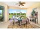 Screened lanai with seating, plants, and views of the lake at 267 Talquin Ct, Englewood, FL 34223
