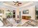 Bright, open living room with a television and sliding doors leading to the lanai at 267 Talquin Ct, Englewood, FL 34223