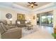 Spacious living room with sliding glass doors and a view of the lanai at 267 Talquin Ct, Englewood, FL 34223