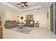 Relaxing living room with a ceiling fan, tile floors, and comfortable seating at 267 Talquin Ct, Englewood, FL 34223