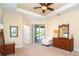 A spacious main bedroom with tray ceiling and access to lanai, plus decorative furniture at 267 Talquin Ct, Englewood, FL 34223