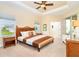 Main bedroom suite featuring a decorative headboard, tray ceiling, and plenty of natural light at 267 Talquin Ct, Englewood, FL 34223