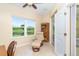 A cozy home office with tile floors, chair, and serene pond views at 267 Talquin Ct, Englewood, FL 34223