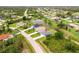 Aerial view of home on a large lot with mature landscaping and a pond in a quiet neighborhood at 271 Antis Dr, Rotonda West, FL 33947