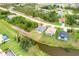 Aerial view of a single-Gathering home with a gray roof in a neighborhood setting at 271 Antis Dr, Rotonda West, FL 33947