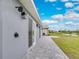 Home exterior featuring outdoor shower and paved patio, plus a serene view of the backyard pond at 271 Antis Dr, Rotonda West, FL 33947
