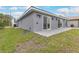 Home exterior highlighting the back patio, sliding glass doors, and a well-maintained lawn at 271 Antis Dr, Rotonda West, FL 33947