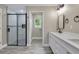 Well-lit bathroom with a glass-enclosed shower, a sleek vanity, and wood-look flooring at 271 Antis Dr, Rotonda West, FL 33947
