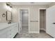 Bathroom with dual sinks, linen closet, and closet with wire shelving at 271 Antis Dr, Rotonda West, FL 33947