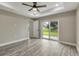 Spacious bedroom with wood-look floors and sliding glass door to backyard at 271 Antis Dr, Rotonda West, FL 33947