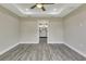 Bedroom with wood-look flooring leading to bathroom with dual sinks at 271 Antis Dr, Rotonda West, FL 33947