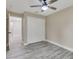 Bedroom featuring gray wood-style flooring, a ceiling fan, and a closet at 271 Antis Dr, Rotonda West, FL 33947