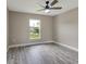 Bedroom featuring wood floors, ceiling fan, and a large window at 271 Antis Dr, Rotonda West, FL 33947
