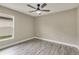 Simple bedroom with laminate floors, ceiling fan and one window to the outside at 271 Antis Dr, Rotonda West, FL 33947