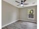 Neutral bedroom showcasing wood-style flooring, a window, and a ceiling fan at 271 Antis Dr, Rotonda West, FL 33947