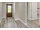 Home foyer featuring a wood front door with glass and gray wood floors at 271 Antis Dr, Rotonda West, FL 33947