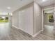 Bright hallway with closet doors leading to the backyard through glass sliding doors at 271 Antis Dr, Rotonda West, FL 33947