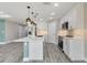 Modern kitchen featuring white cabinets, stainless steel appliances, and a spacious island with pendant lighting at 271 Antis Dr, Rotonda West, FL 33947