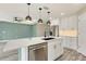 Close-up of the kitchen island with modern fixtures and stainless steel appliances at 271 Antis Dr, Rotonda West, FL 33947