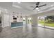 Bright kitchen with an island and stainless steel appliances, adjacent to sliding glass doors at 271 Antis Dr, Rotonda West, FL 33947