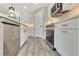Modern kitchen featuring white cabinetry, stainless steel appliances, modern gold hardware, and wood-look flooring at 271 Antis Dr, Rotonda West, FL 33947