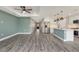 Expansive living area with new floors connecting to the kitchen and entryway at 271 Antis Dr, Rotonda West, FL 33947