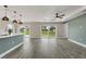 Spacious open-concept living room with a kitchen island, recessed lighting, and sliding glass doors at 271 Antis Dr, Rotonda West, FL 33947